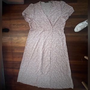 Plus size wrap dress from Nasty Gal in a blush floral print with button detail